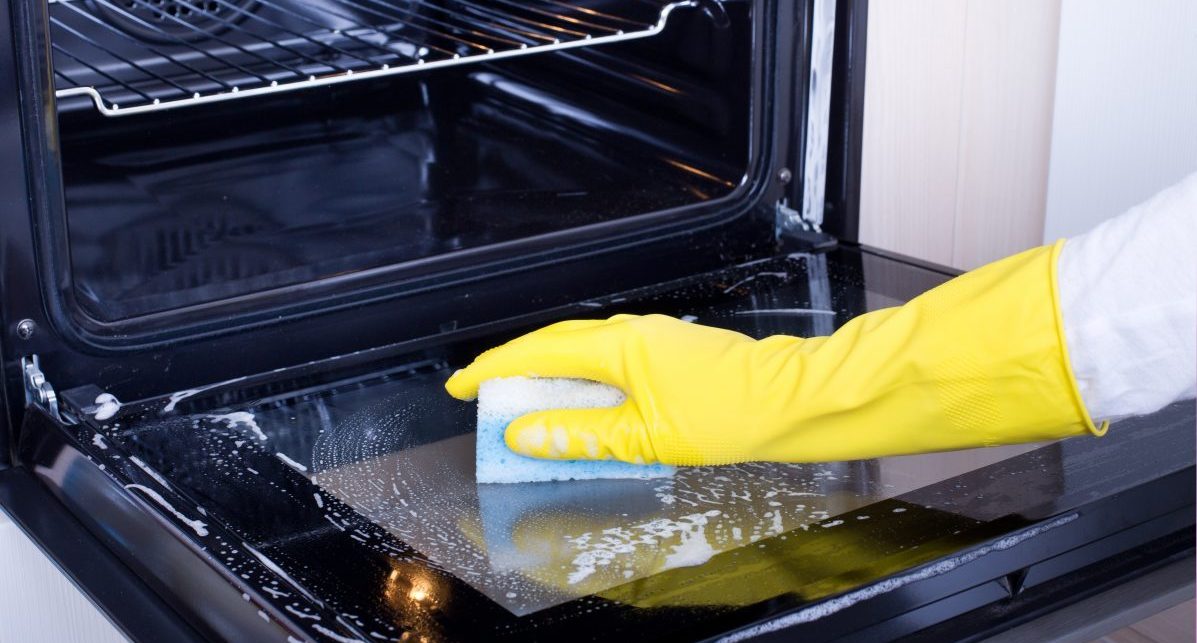 Woman Cleaning Oven